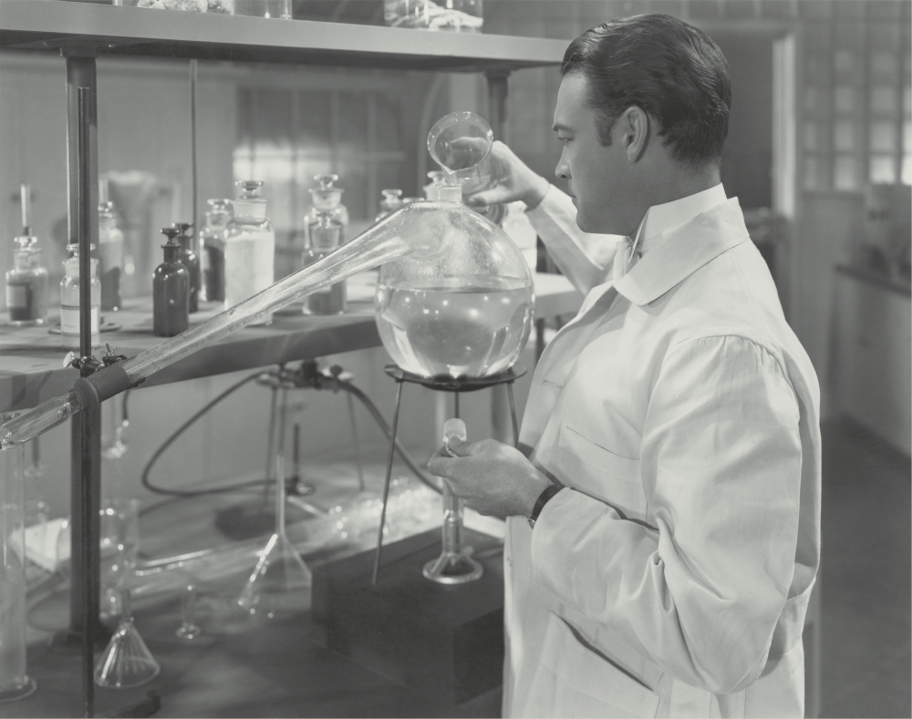 A scientist engaging his retort flask